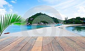 Empty wood desk and summer blue sea background and leaf coconut palm tree .Blank space for text and images.Concept Summer,