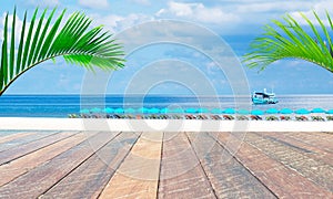 Empty wood desk and summer blue sea background and leaf coconut palm tree .Blank space for text and images.Concept Summer,