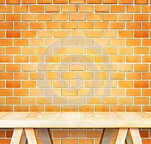 Empty wood modern table and grunge orange brick wall in background,Mock up template for display of your product.