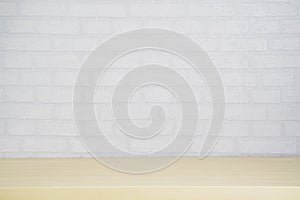 Empty wood plate top table on gray brick background.