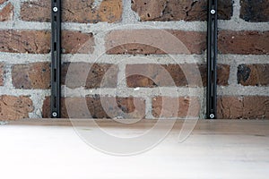 Empty wood shelf on old brick wall background, grunge industrial interior background texture