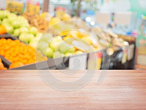 Empty wood table on blur of supermarket, Fruit Department, For montage product display.