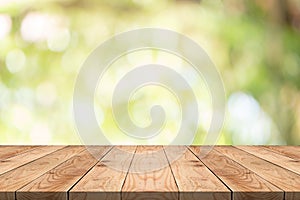 Empty wood table on blurred background copy space for montage your product or design,Blank brown board with abstract blurred