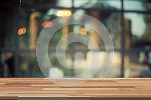 Empty wood table and Blurred background display at coffee shop w