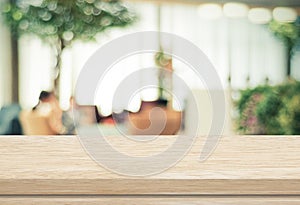 Empty wood table and blurred cafe with bokeh light background