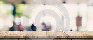 Empty wood table and blurred light table in coffee shop and cafe with bokeh background. product display template