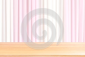 Empty wood table floors on blurred fabric wedding backdrop light pink and white curtain, wood table board empty front fabric pink