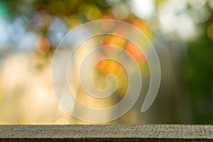 Wood table over blurred trees with bokeh background