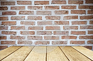Empty wood table over brick wall background, product display