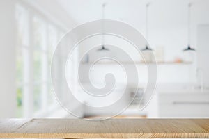 Empty wood table over modern light interior of kitchen background