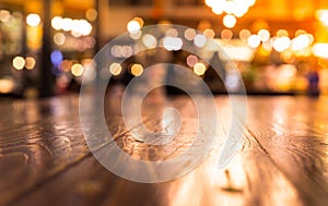 Empty wood table top bar on blur cafe restaurant in dark background