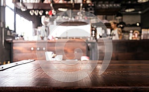 Empty wood table top with blur of abstract coffee shop or cafe