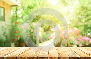 Empty wood table top on blur abstract green from garden