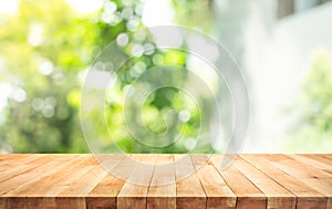 Empty wood table top on blur abstract green from garden and home area background