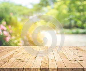 Empty wood table top on blur abstract green from garden and home area background