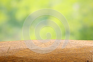 Empty wood table top on blur abstract green from garden and house in morning