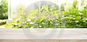 Empty wood table top on blur abstract green from garden morning