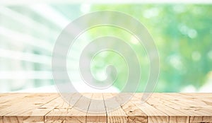 Empty wood table top on blur abstract green garden from window view background