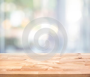 Empty wood table top on blur abstract  window glass view