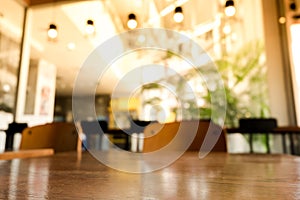 Empty wood table top with blur coffee shop or cafe restaurant background