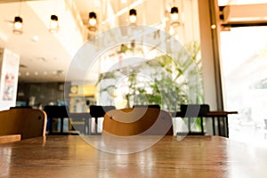 Empty wood table top with blur coffee shop or cafe restaurant background