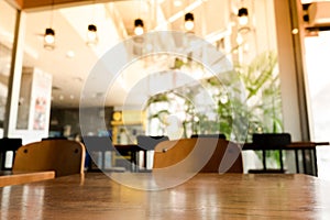 Empty wood table top with blur coffee shop or cafe restaurant background
