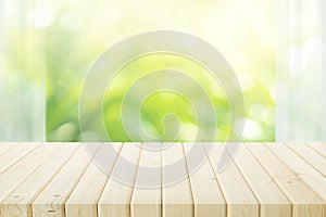 Empty of wood table top on blur of curtain with window view green from tree garden background