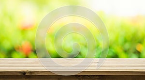 Empty of wood table top on blur of fresh green abstract