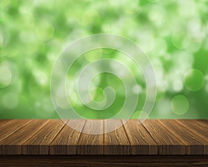 Empty of wood table top on blur of fresh green abstract from garden backgrounds.For montage product display or key