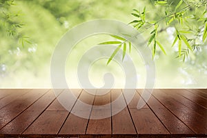 Empty of wood table top on blur of fresh green abstract from garden with sunlight .For montage product display or design key