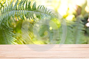 Empty of wood table top on blur of fresh green nature abstract f