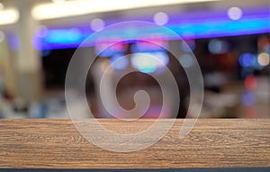 Empty wood table top and blur of night market background/selective focus .For montage product display.