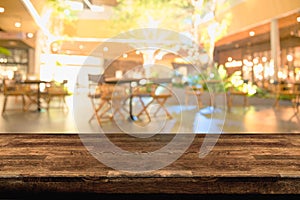 Empty wood table top and blur of night pub or restaurant background/selective