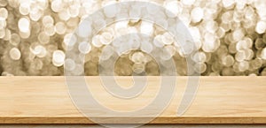 Empty wood table top with blur sparkling gold bokeh abstract background,panoramic banner for display or montage
