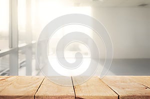 Empty of wood table top with blur sunlight in window building.