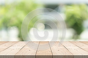 Empty wood table top on blurred background at garden in shopping mall, copy space for montage you product photo