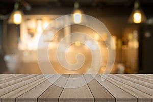 Empty wood table top on blurred background form coffee shop photo