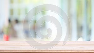 Empty wood table top and blurred of interior restaurant with window view green from tree garden background background - can used