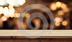 Empty of wood table top with blurred light gold bokeh