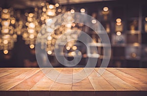 Empty of wood table top with blurred light gold bokeh abstract background