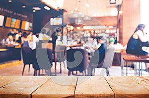 Empty of wood table top on blurred of people in coffee shop