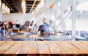 Empty of wood table top on blurred of people in coffee shop