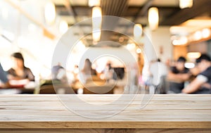 Empty of wood table top on blurred of people in coffee shop