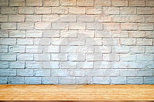 Empty wood table top and brick background with copy space.