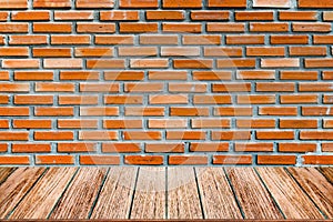 Empty wood table top and brick background with copy space.