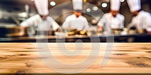 Empty Wood table top with Chef cooking in restaurant kitchen blurred defocused background