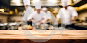 Empty Wood table top with Chef cooking in restaurant kitchen blurred defocused background