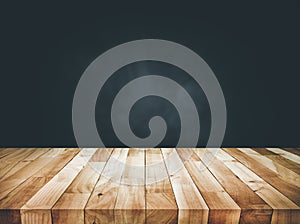 Empty wood table top counter on dark wall background.For create product display or design key visual