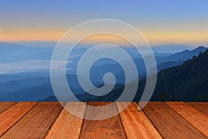Empty wood table top with mountain background at sunrise