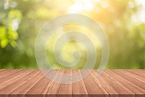 Empty wood table top on nature green blurred background at garden,space for montage show products photo